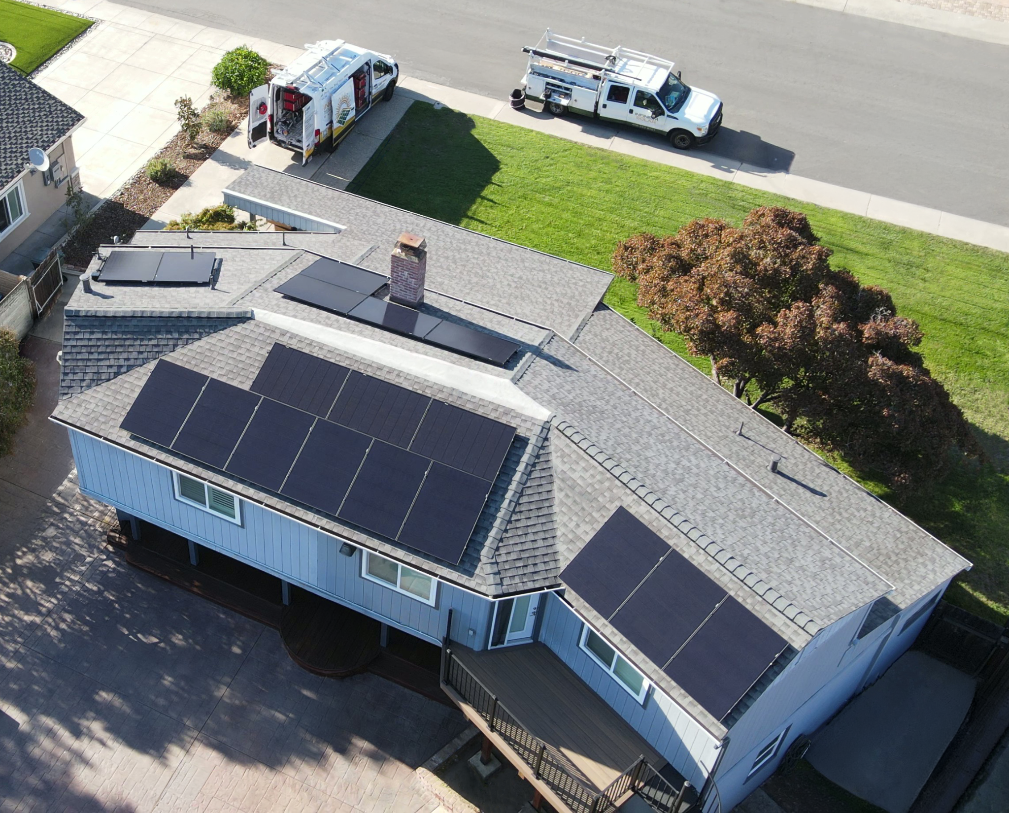 Home with a shingle roof with solar panels installed